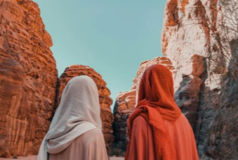 Travellers exploring the red rock canyons of AlUla