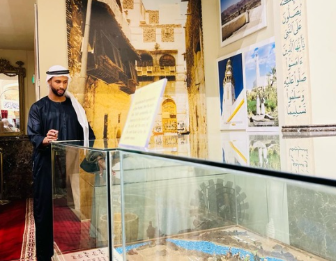 Local host presenting a heritage exhibit in Madinah