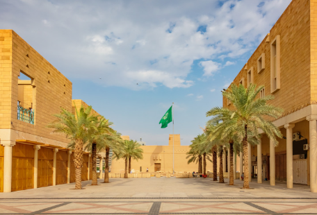 Palm-lined square at Diriyah with the Saudi flag