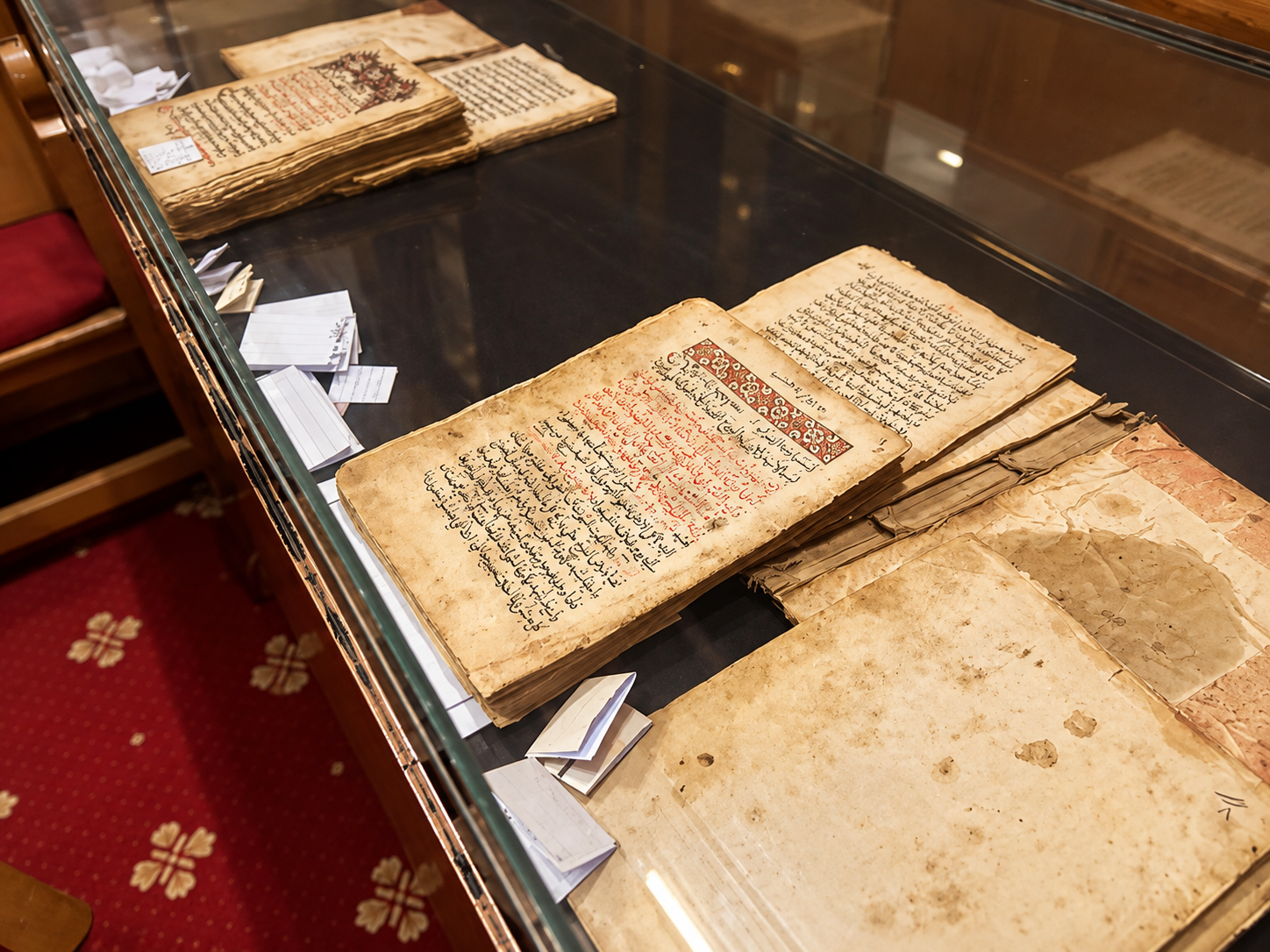 Ancient Coptic manuscripts from the monastery collection displayed under glass