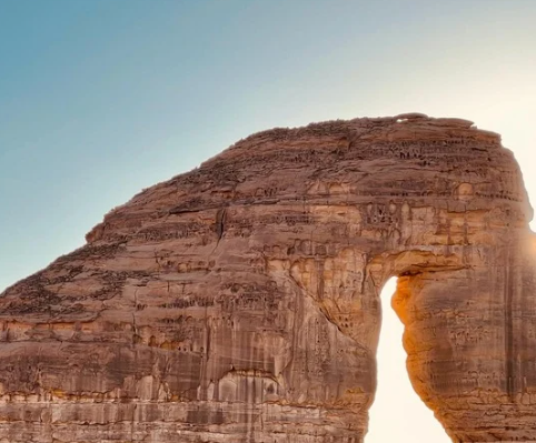 Elephant Rock, the natural sandstone arch of AlUla, at golden hour