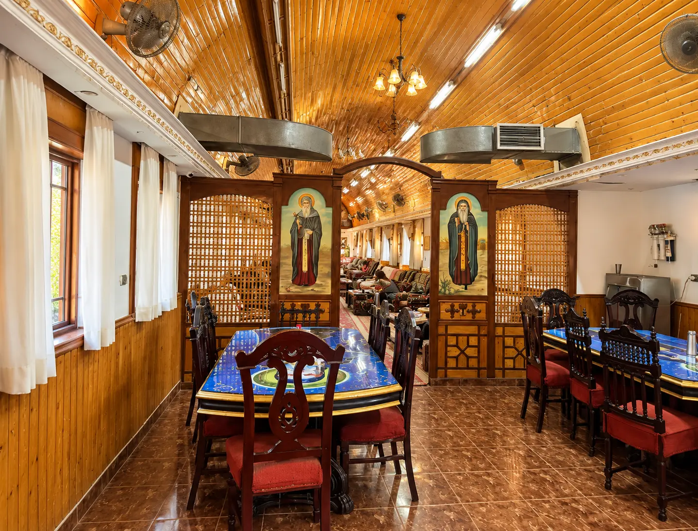 The monastery dining hall with blue tables, where hospitality is shared with guests